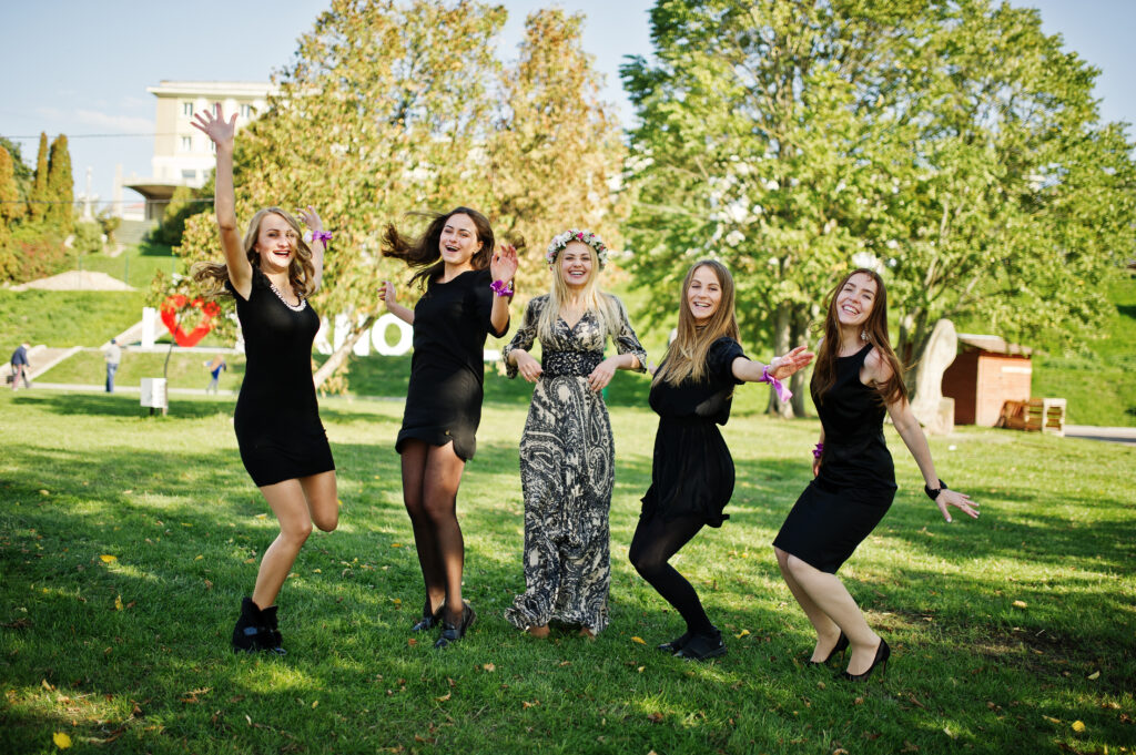 Five girls wear on black jumping at hen party.