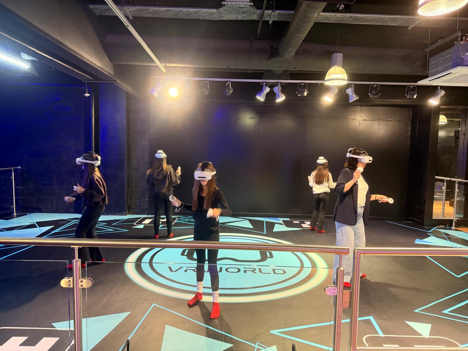VR World players wearing headsets in a dark neon-lit room